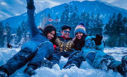 3 women lying on snow covered ground during daytime