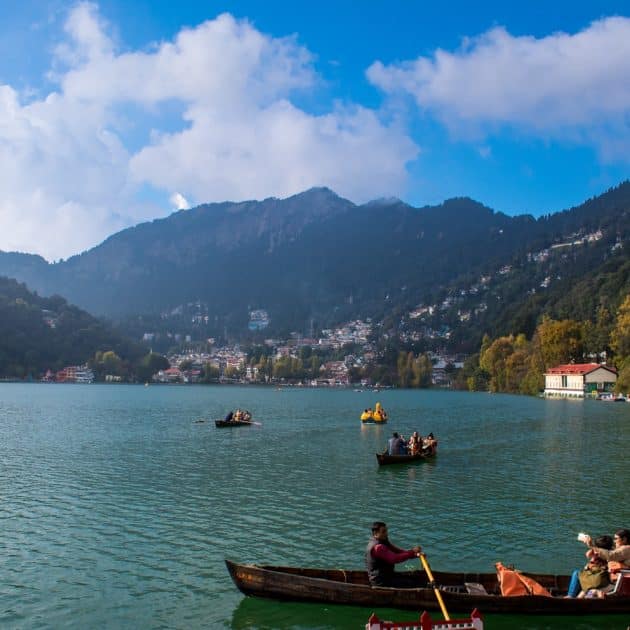 a group of people rowing boats